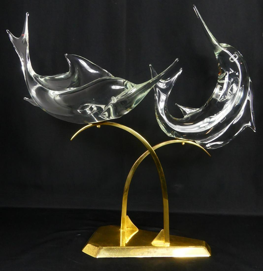 PR LICIO ZANETTI MURANO GLASS FISH w BRASS BASE: Pair of Licio Zanetti Murano colorless art glass swordfish on brass base. Each fish signed to underside. Includes Certificate of Authenticity hand signed by Licio Zanetti. Larger fish measures 18 1/2"