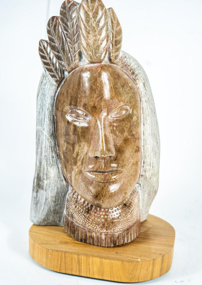 ADRIAN J BECKWITH NATIVE AMERICAN MARBLE SCULPTURE: Adrian J Beckwith (American, 20th C) carved marble sculpture depicting a Native American Indian. Signed to underside and dated March 1992. Measures 16" height + 1 1/2" rotating wood stand.