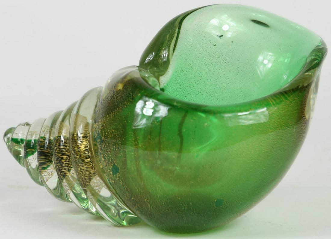 MURANO GLASS GOLD FLECK SEASHELL: Murano art glass sculptural bowl or vase in form of a spiraled shell in green with gold fleck. Measures 7" length x 4 3/4" height.