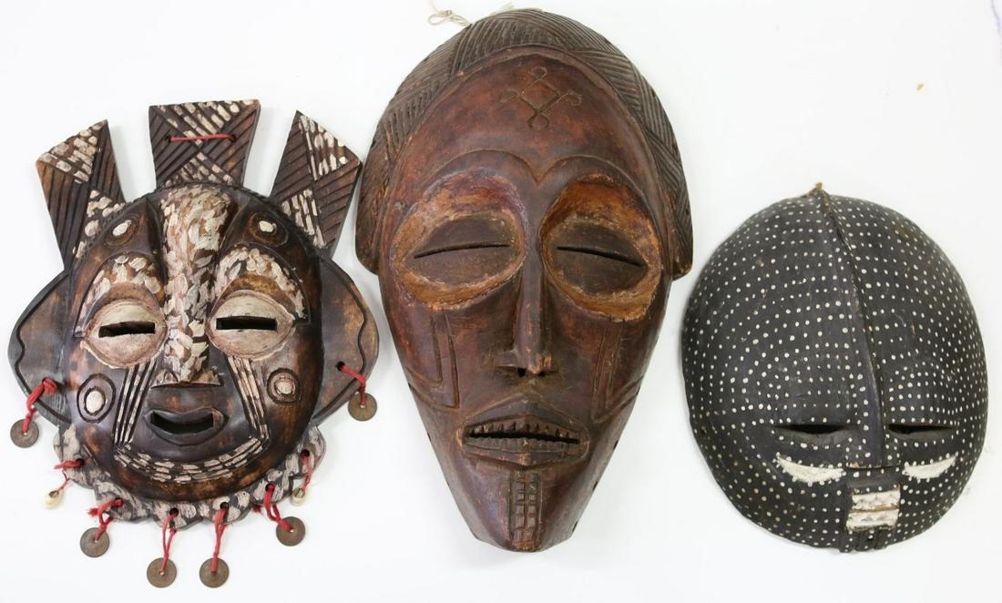 3pc TRIBAL MASKS AFRICAN & GHANESE: Three carved wood tribal masks. One African black ground with white spotted pigment-12 3/4". One African having geometric headdress-19 1/2". One Ghanese with coins and shells-17".