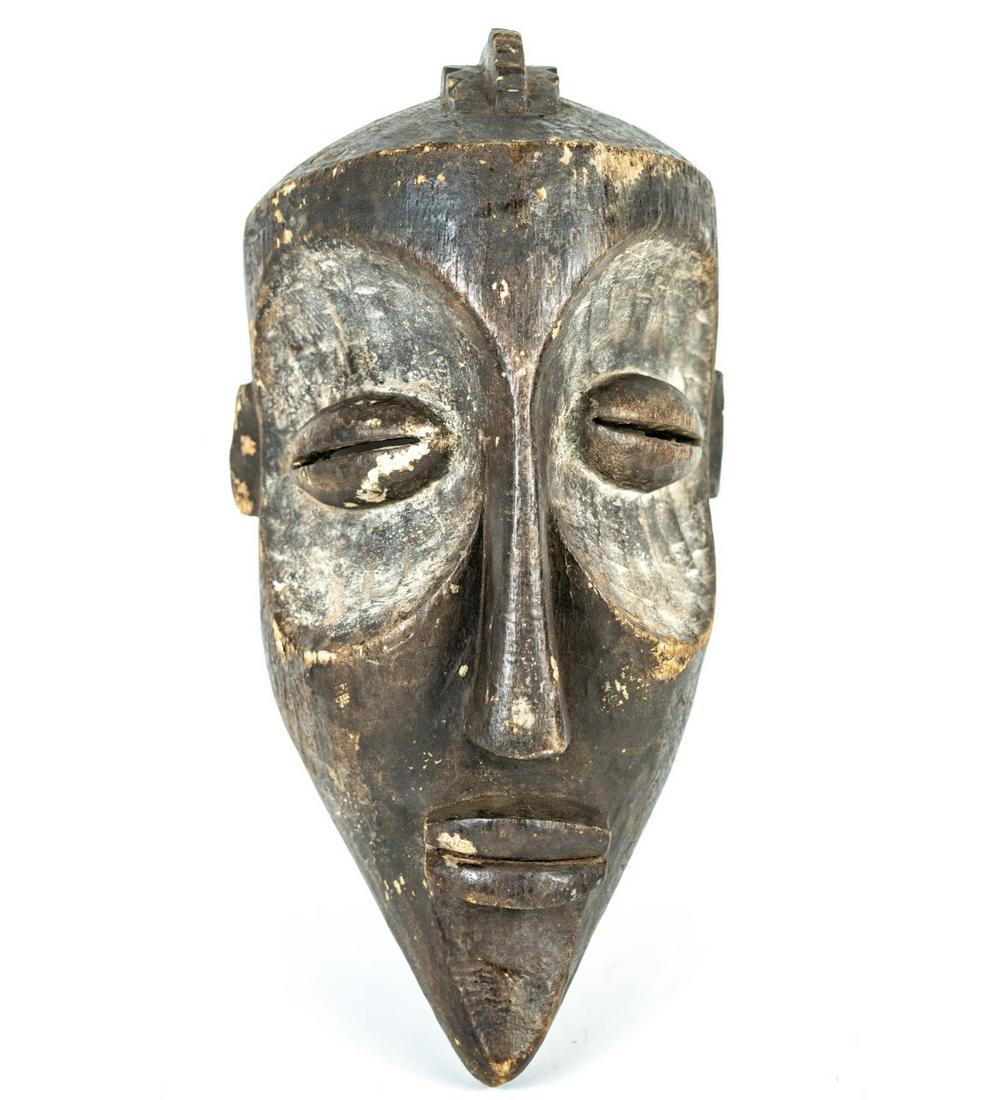 AFRICAN CARVED PENDE TRIBAL MASK: African carved wood Pende tribal mask having slit eyes and pointed chin. Measures 17 1/4" length x 8 1/2" width.