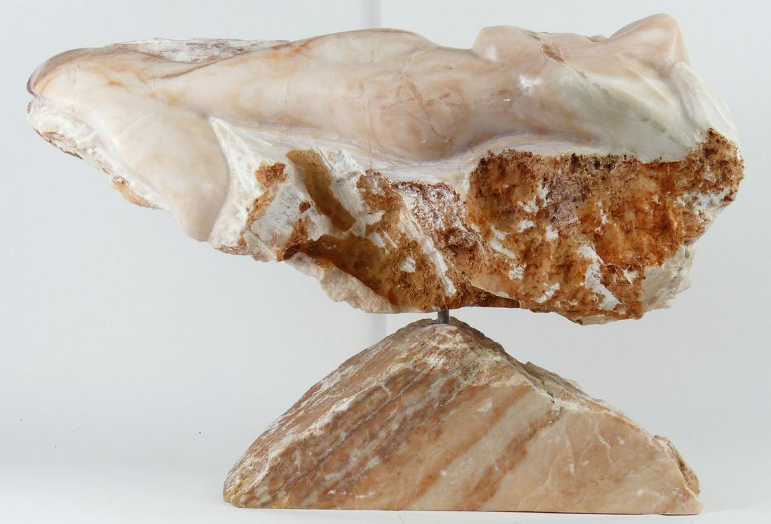 RECLINING NUDE MARBLE SCULPTURE: Marble sculpture depicting a reclining nude female figure on a natural rock-form base. Possibly Native American. Measures 21 3/4" length.