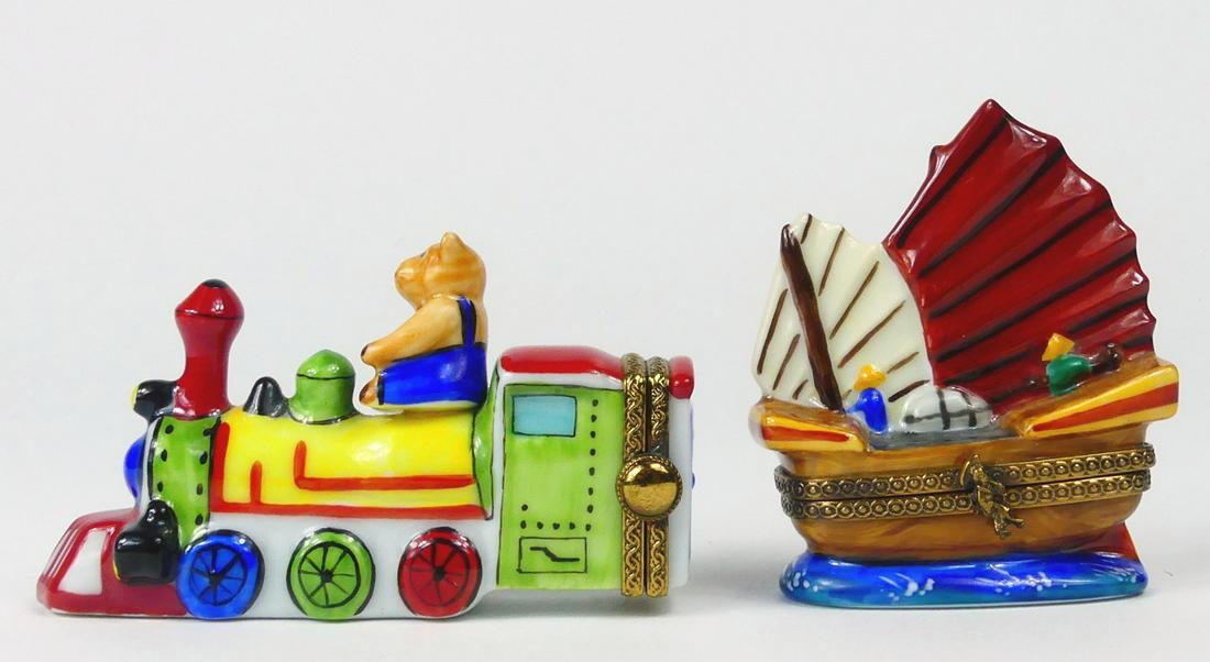 2pc LIMOGES PORCELAIN TRINKET BOXES: TRAIN & SHIP: Two Limoges porcelain figural trinket or pill boxes. Includes a train engine and boat. Each marked to underside. Largest measures 3 1/4" length.