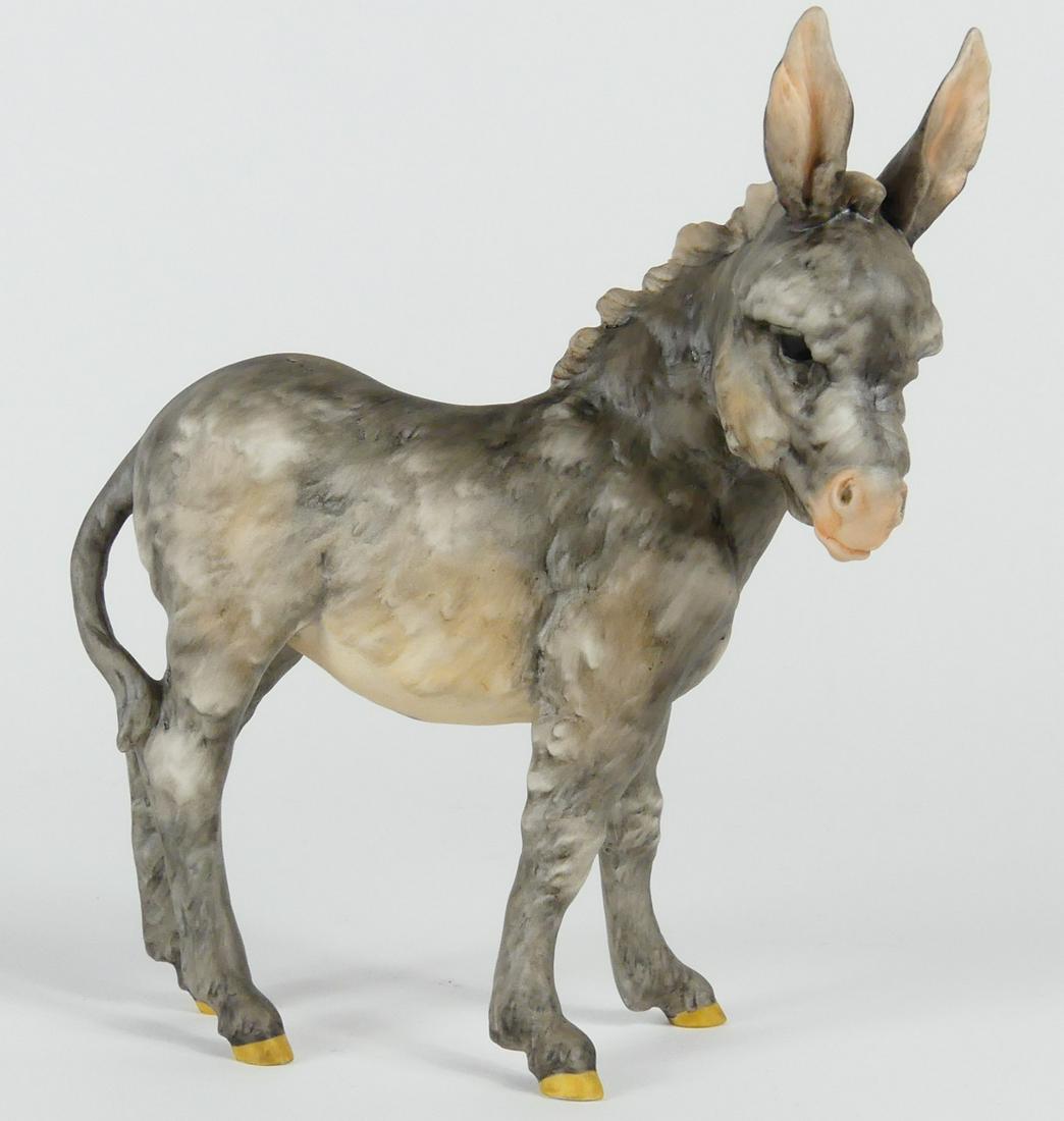 KAISER PORCELAIN DONKEY FIGURINE: Kaiser porcelain figure of a donkey. Marked to underside. Measures 5 1/2" length x 6" height.