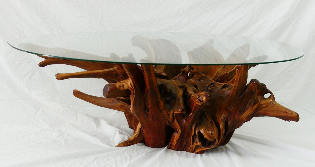 FREEFORM WOOD COFFEE TABLE: Natural free-form wood coffee table with glass top. Base measures 40" length x 27" width x 16 1/2" height.. Glass top measures 48" x 32".