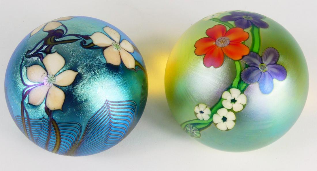 2pc ORIENT & FLUME IRIDESCENT GLASS PAPERWEIGHTS: Two Orient & Flume iridescent studio art glass paperweights with floral decoration. Each signed, dated and holds original label to underside. Each measures approx 2 3/4" diameter.
