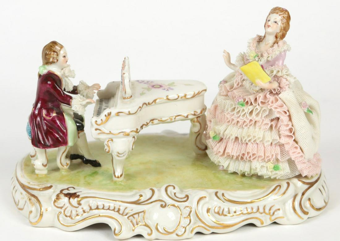 MZ IRISH DRESEN LACE PIANIST & SINGER GROUPING: MZ Irish Dresden lace porcelain figural grouping depicting a pianist and singer. Marked to underside. Measures 7 1/2" length x 4 3/4" height.