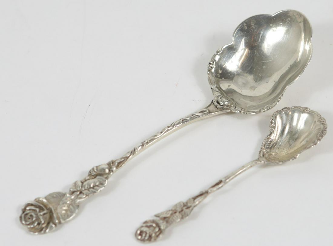 2pc GERMAN 800 SILVER ROSE SERVING SPOONS: Two German 800 silver serving spoons with rose motif. Each marked 800 with hallmarks. Largest measures 7 1/4" length. Total weight 2ozt.
