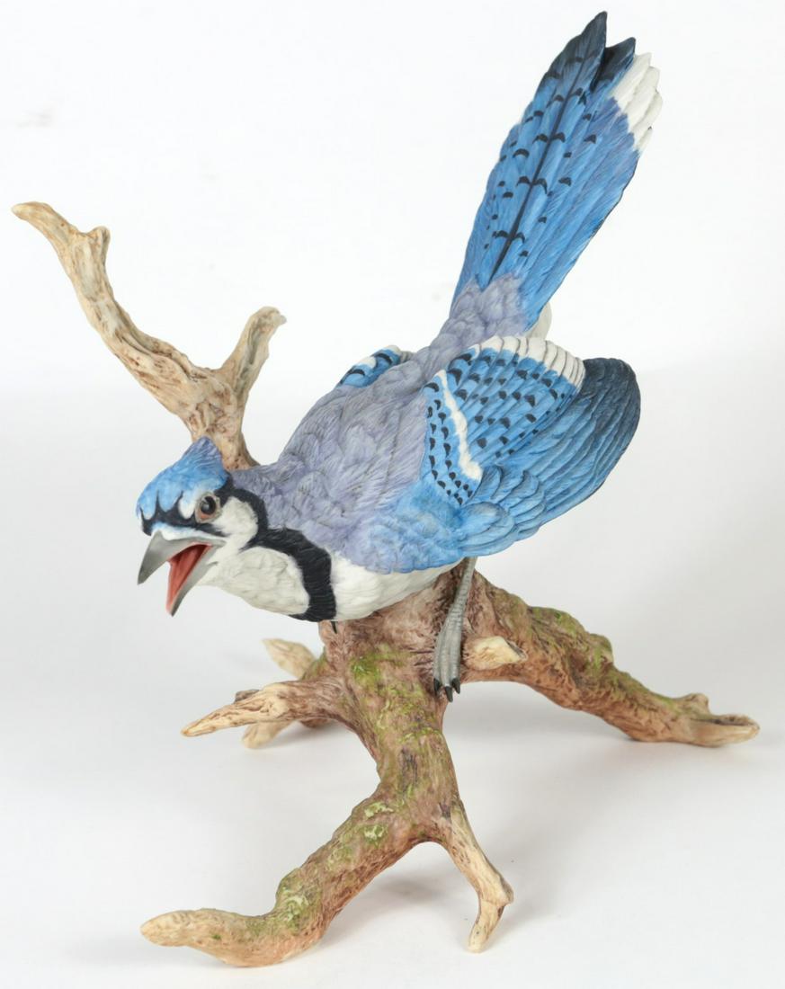 BOEHM 'BLUE JAY' PORCELAIN BIRD FIGURINE: Boehm porcelain figure depicting a blue jay perched on branch. Marked, titled and numbered 40234 to underside. Measures 9" height x 8" width.