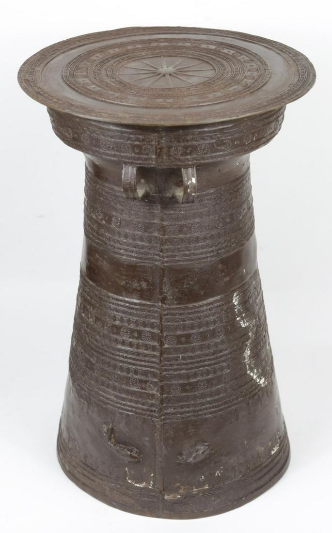 SOUTHEAST ASIAN BRONZE RAIN DRUM: Southeast Asian bronze rain drum. Circular top features star to center with concentric bands having geometric patterns. Body is flanked by strap handles and has bands of decoration throughout. Measure