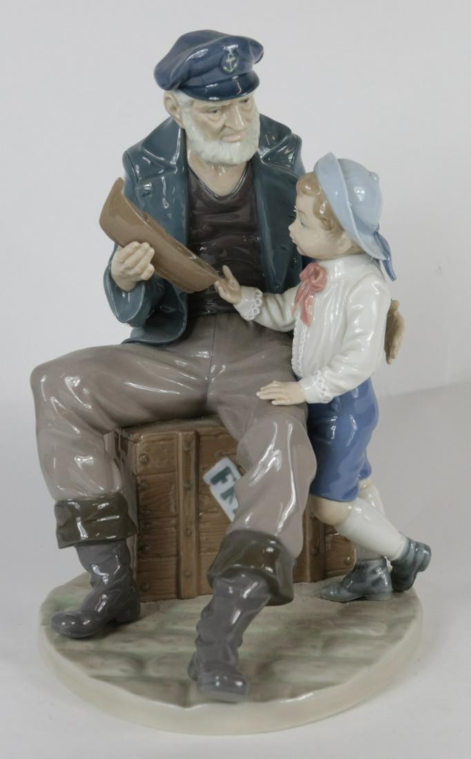 LLADRO 'BOY w SEA CAPTAIN' PORCELAIN FIGURINE: Lladro porcelain figural group titled 'A Tall Yarn' #5207. Marked to underside. Measures 10 1/2" height.