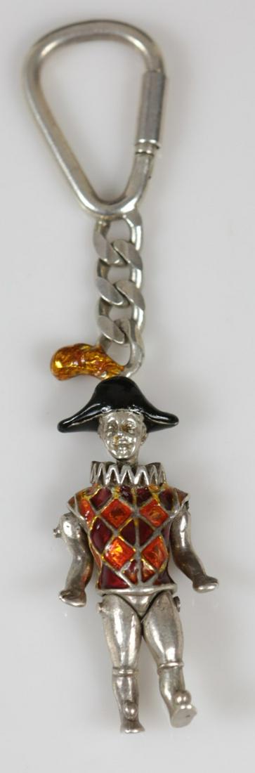 GENE MOORE FOR TIFFANY STERLING & ENAMEL KEY CHAIN: Gene Moore for Tiffany & Company sterling silver and enamel key ring in the form of a harlequin. Having articulated joints along the shoulders, head, and waist. Marked Sterling, Tiffany & Co. Measures
