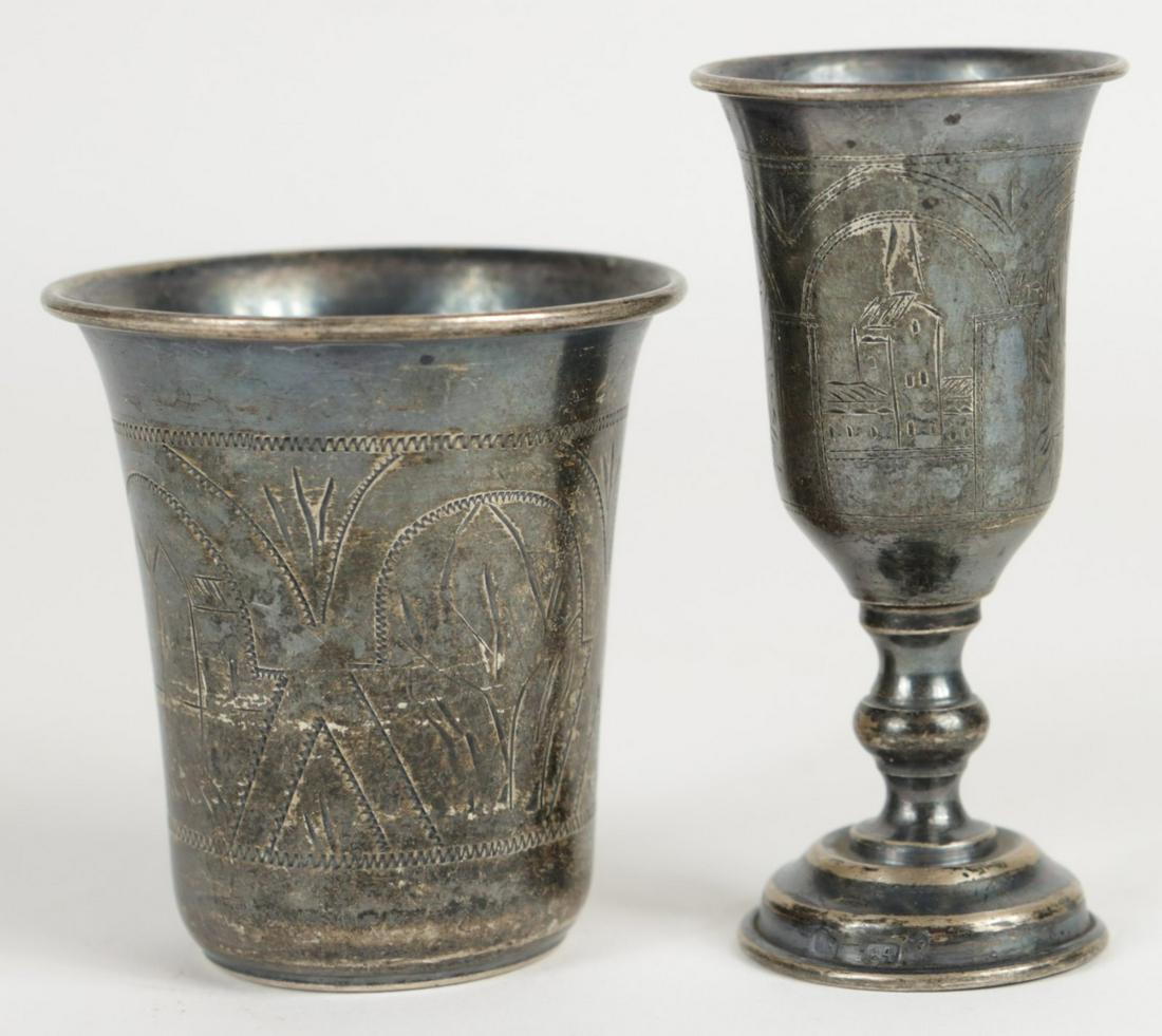 2pc RUSSIAN 84 SILVER KIDDUSH CUPS: 2 Russian 84 silver kiddush cups. Each features four panels engraved with landscapes / buildings. Each impressed 84. Footed also marked IS and measures 3 5/8" height. Total weight 6.5ozt.