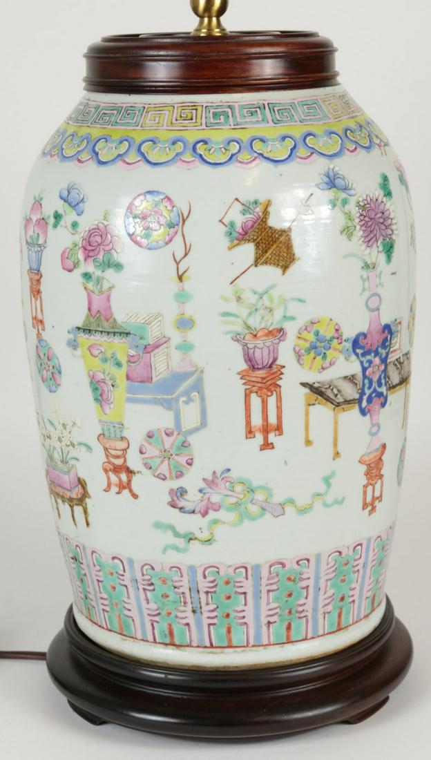 CHINESE LARGE FAMILLE ROSE PORCELAIN JAR LAMP: Large Chinese Famille Rose porcelain jar with wooden cover mounted as a lamp. Decorated with Buddhist symbols throughout. Lamp having a carved agate finial. Porcelain jar measures 12" height. Lamp mea
