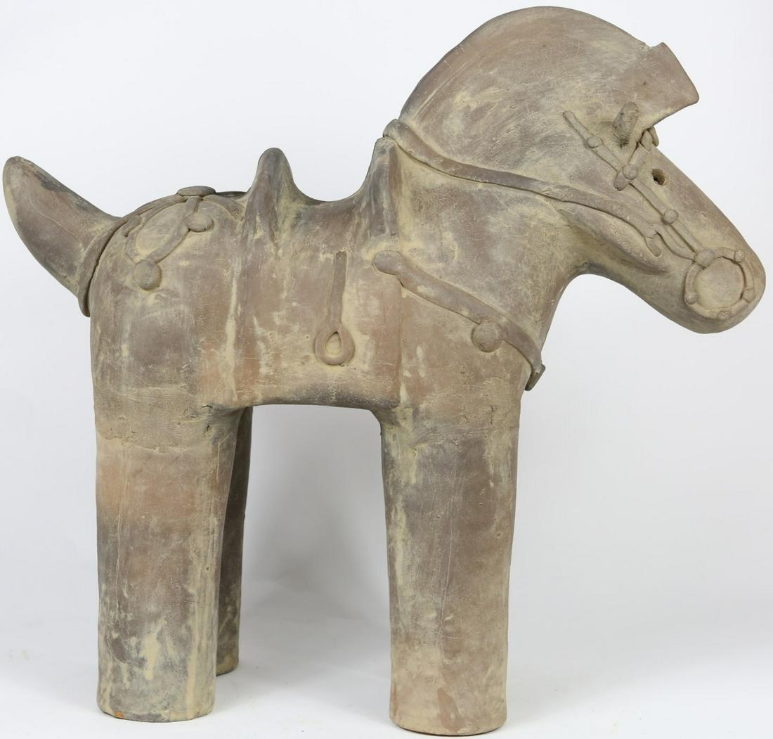 JAPANESE HANIWA POTTERY HORSE SCULPTURE: Japanese Haniwa terracotta sculpture of a horse with saddle. Measures 19" length x 17" height.