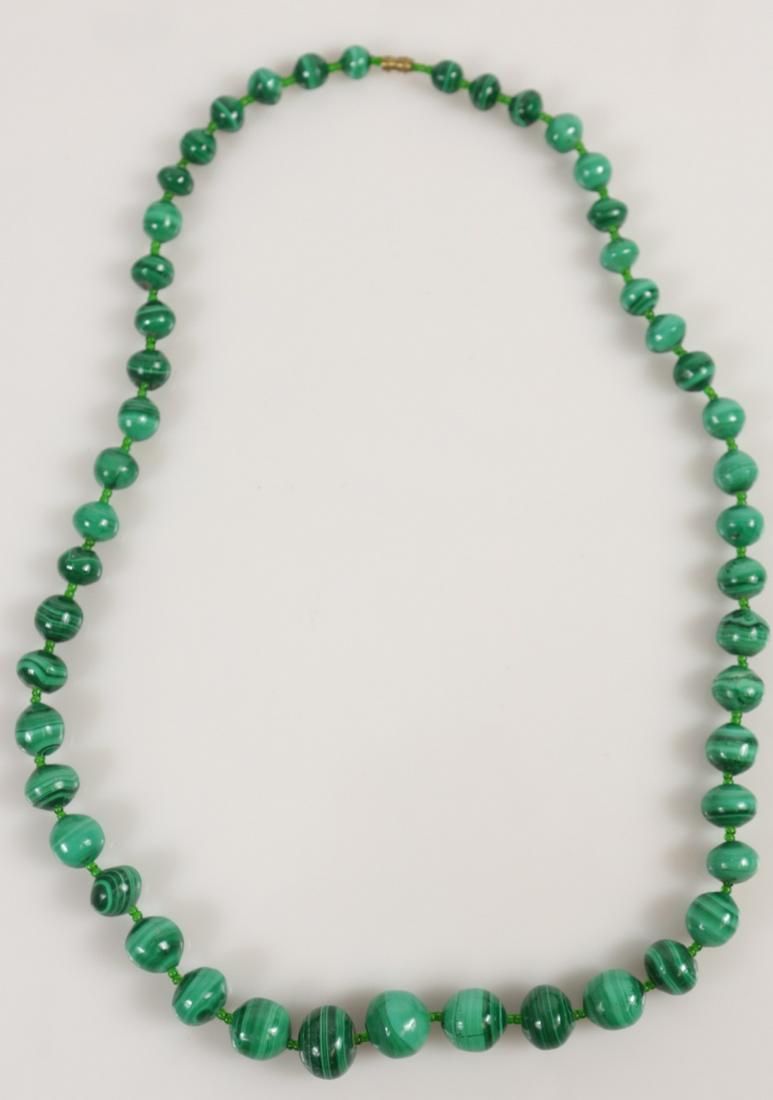CHINESE MALACHITE BEADED NECKLACE: Chinese malachite beaded necklace with screw clasp. Largest center bead measures approx 14mm. Measures 22" length.