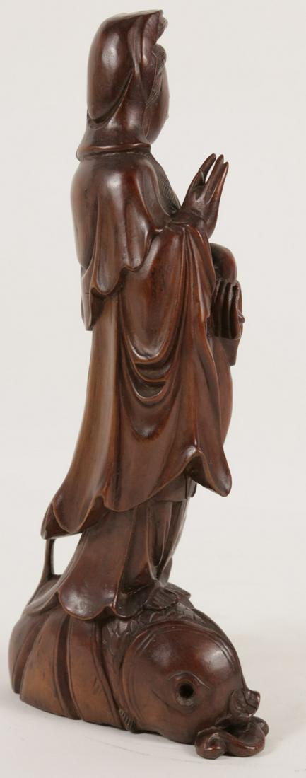 CHINESE CARVED HARDWOOD GUANYIN: Chinese hardwood carving depicting Guan Yin with ruyi scepter standing on a koi fish. Measures 11 1/4" height.