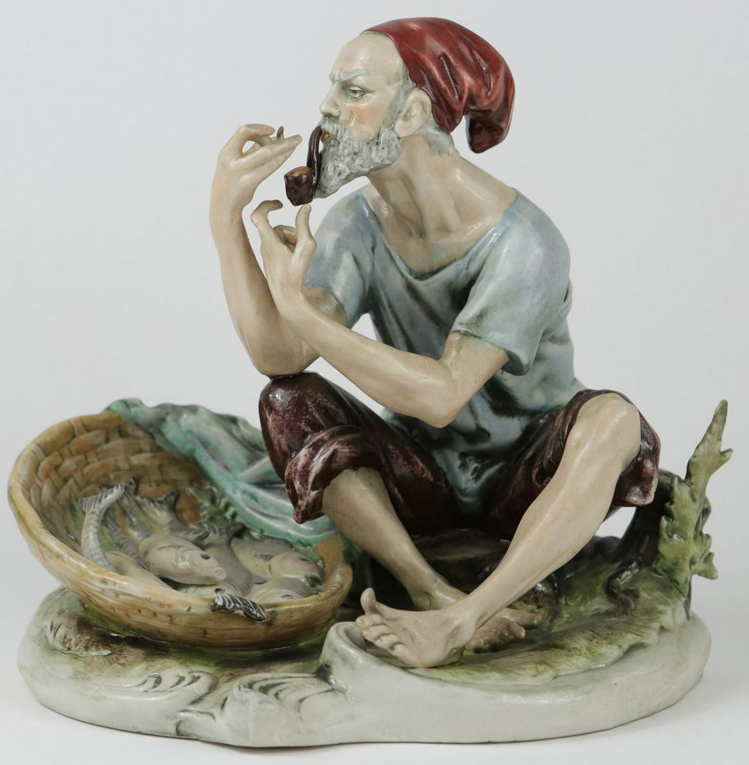 CAPODIMONTE PORCELAIN FISH MERCHANT SCULPTURE: Capodimonte porcelain figure of a fish merchant smoking a pipe. Marked to underside and numbered 508. Measures 9" width x 8 3/4" height.