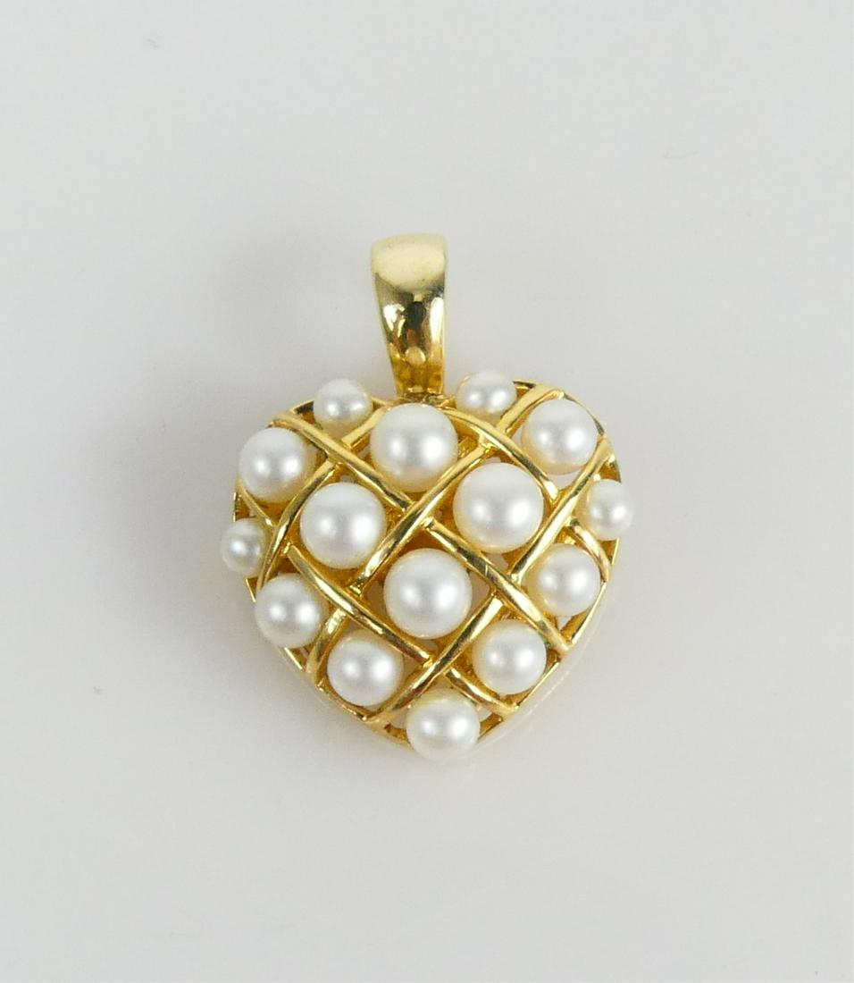 14K YELLOW GOLD & PEARL OPENWORK PENDANT: 14kt yellow gold and pearl openwork pendant with hinged bail. Hallmarked and marked 14K. Measures 3/4" width x 1" height including bail. Total weight 4g.