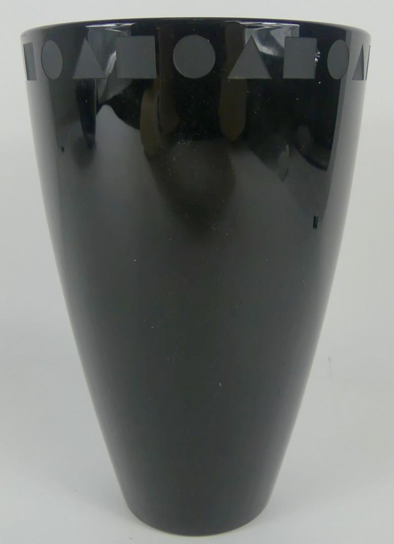 WARD BENNETT FOR SASAKI BLACK CRYSTAL VASE: Ward Bennett for Sasaki (c. 1975), this thick-walled black crystal vase from the Sengai line has a flat cut-polished top decorated with a row of repeated carved triangles, squares, and circles around