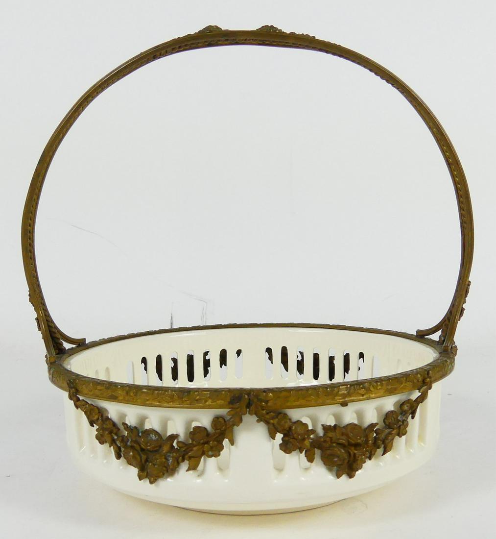 WAECHTERSBACH GERMAN PORCELAIN & GILT BASKET: Waechtersbach German porcelain and gilt metal basket. Marked to underside. Measures 6 3/4" height x 6" width.