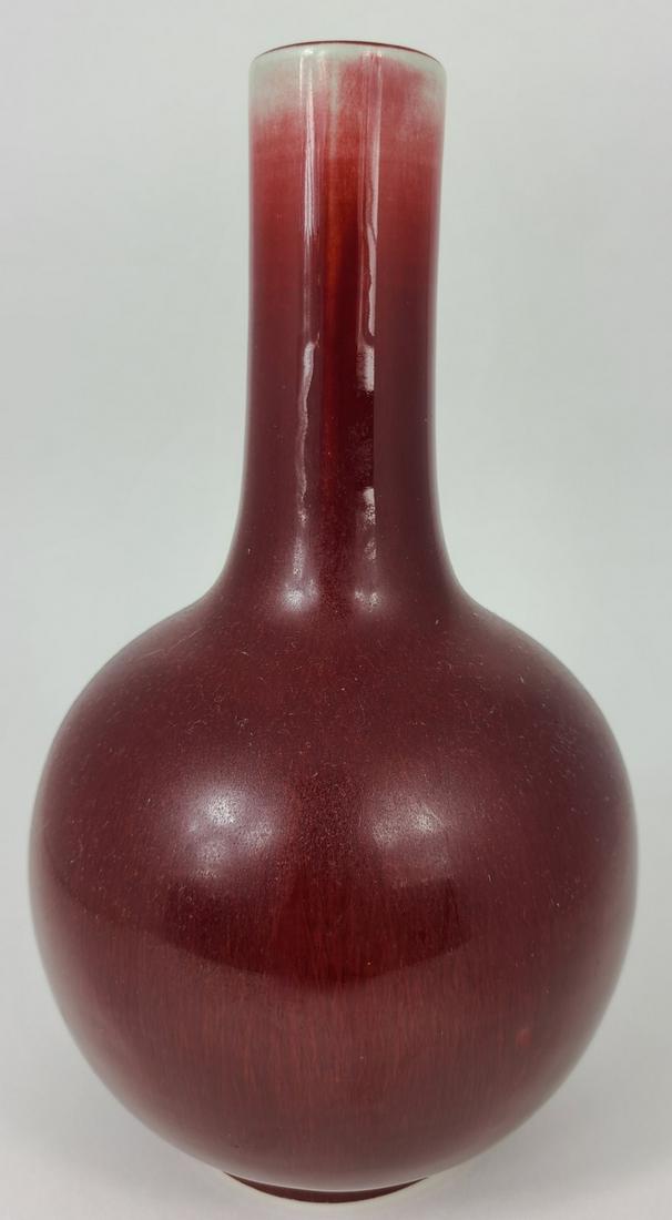 CHINESE SANG DE BOEUF GLAZED PORCELAIN VASE: Chinese oxblood glazed porcelain vase. Marked to underside. Measures 9 1/4" height.