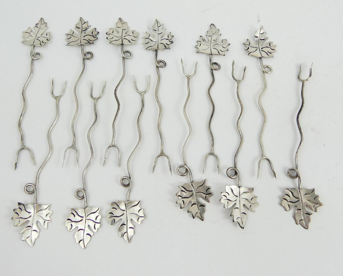 12pc STERLING SILVER LEAF APPETIZER PICKS: 12 sterling silver appetizer picks with leaf handles. Each marked Sterling, 925 and measures 3 3/4". Total weight 0.9ozt.