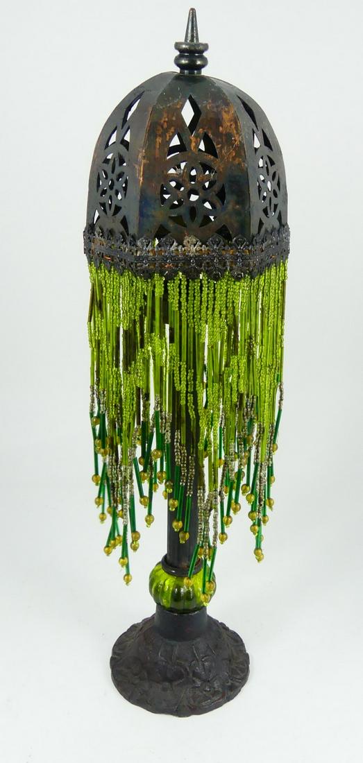 BEADED FRINGE BOUDOIR CANDLE LAMP: Boudoir candle holder lamp with cast metal base. Reticulated metal shade with hanging green beads. Measures 17" height.