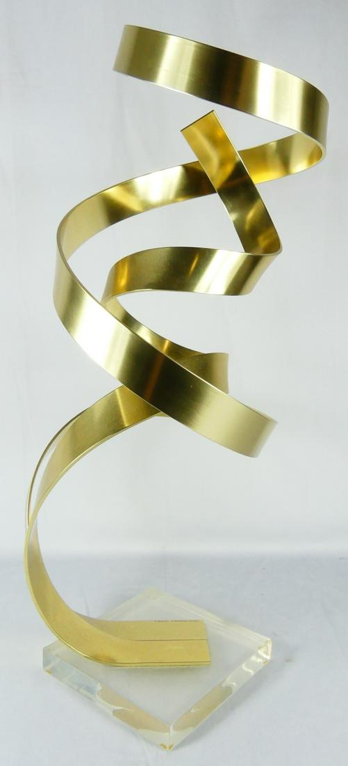 DAN MURPHY BRASS LUCITE ABSTRACT KINETIC SCULPTURE: Dan Murphy abstract brass sculpture on lucite base. Signed and dated 1982. Measures 25" height.