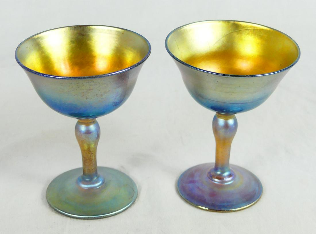 PR LC TIFFANY FAVRILLE GLASS GOBLETS: Pair of Louis Comfort Tiffany Aurene art glass wine goblets. Each signed LCT Favrille to underside and measures 3 7/8" height.