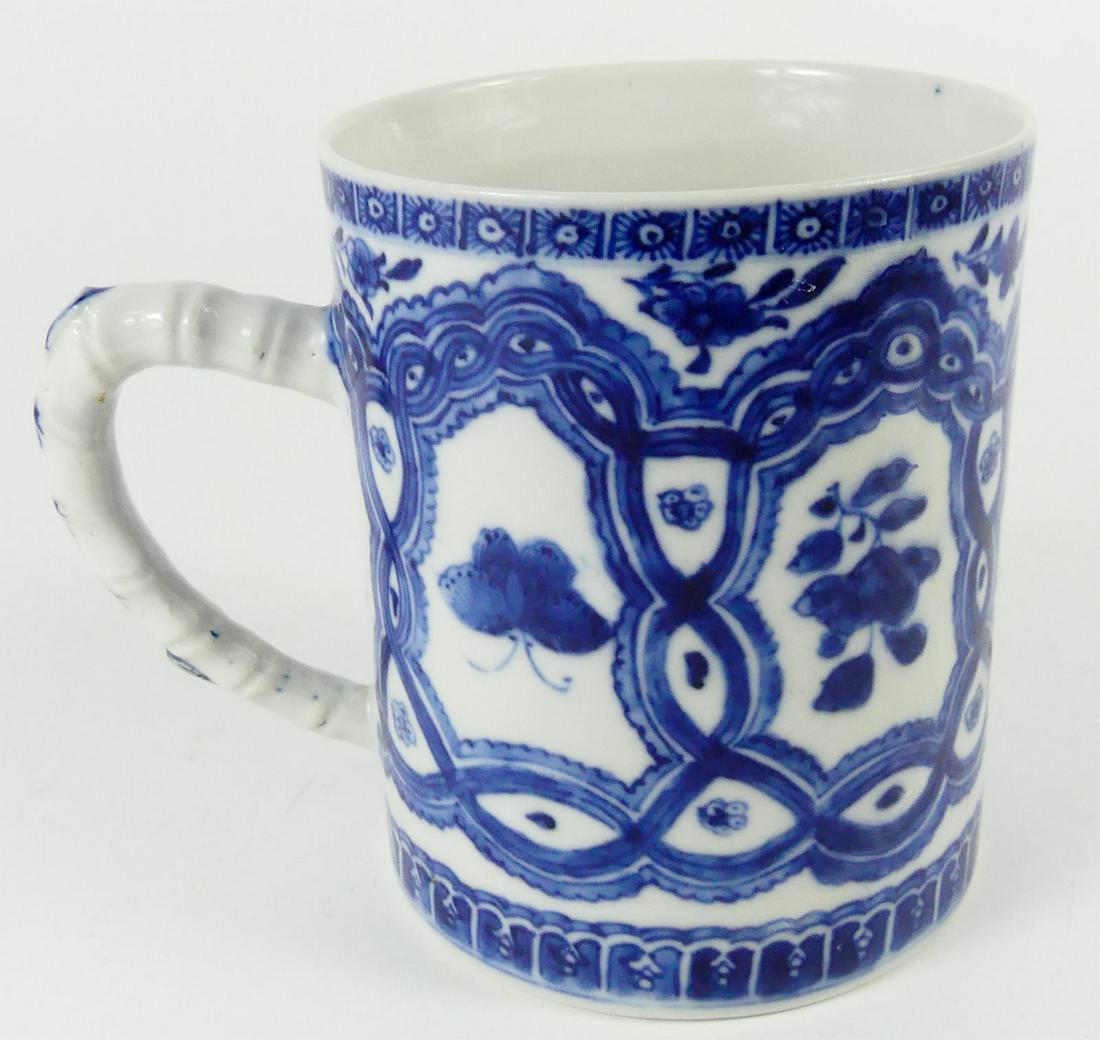 CHINESE EXPORT BLUE & WHITE PORCELAIN MUG: Chinese export blue and white porcelain mug with bamboo form handle. Measures 4 5/8" height x 5 3/8" width including handle.
