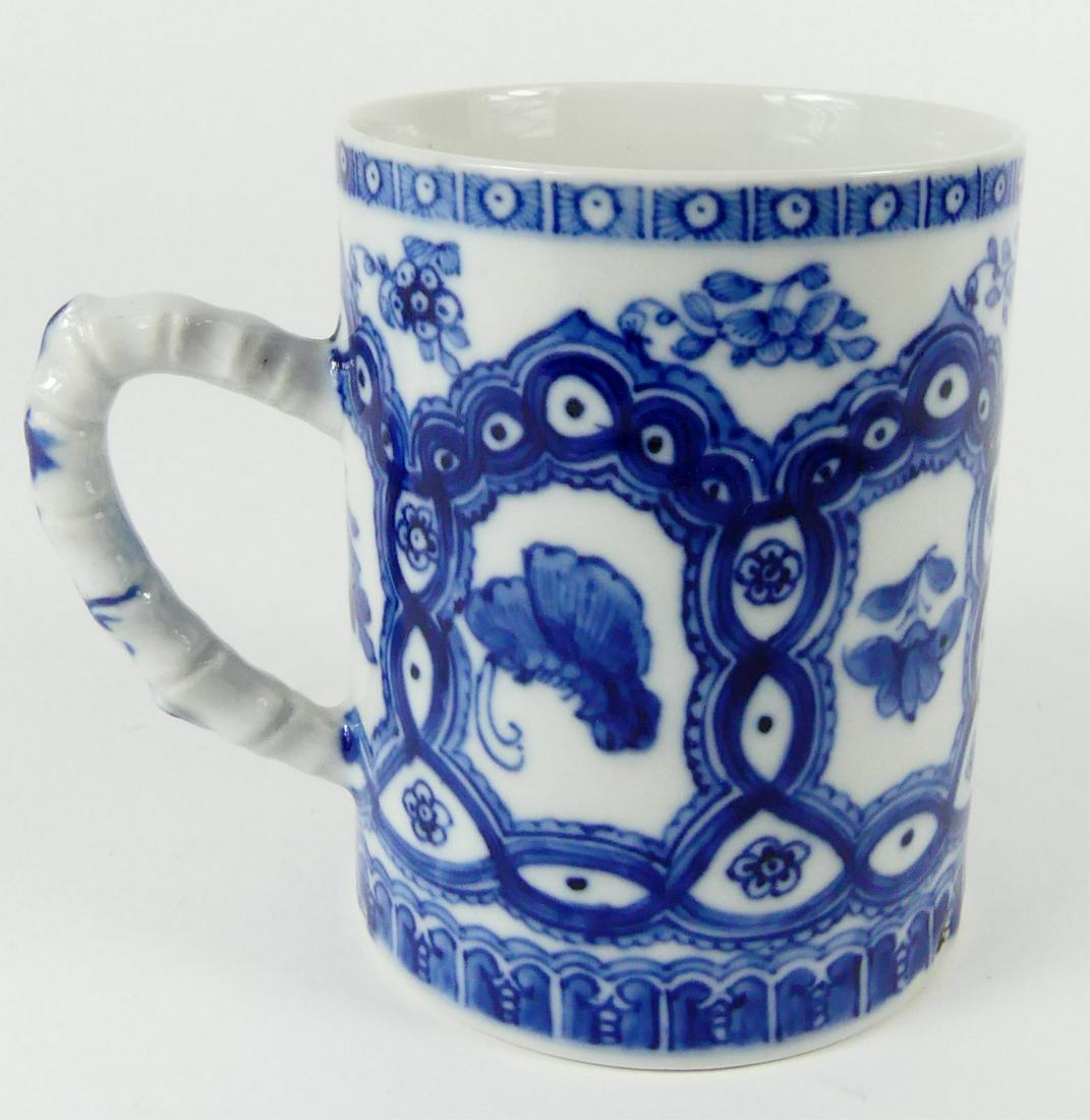 CHINESE EXPORT BLUE & WHITE PORCELAIN MUG: Chinese export blue and white porcelain mug with bamboo form handle. Measures 4 1/4" height x 4 5/8" width including handle.