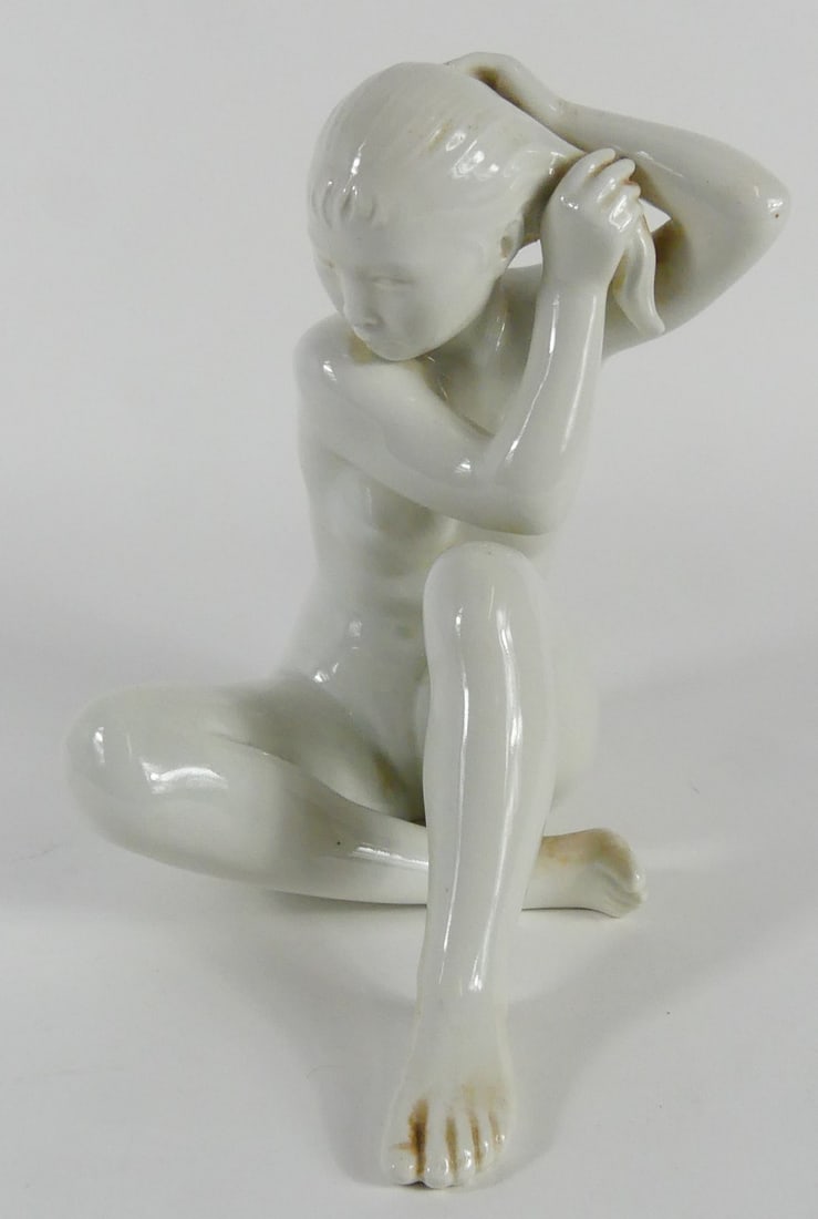 BING & GRONDAHL BLANC DE CHINE NUDE FIGURE: Bing and Grondahl Blanc de Chine porcelain figurine depicting a seated nude female figure. Marked to underside. Measures 9 1/4" x 8 1/2" length.
