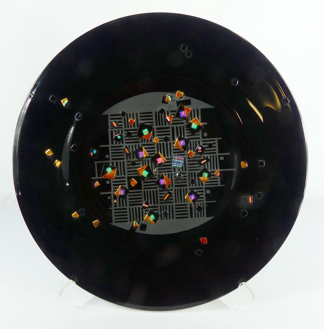 FUSED ART GLASS CHARGER SIGNED: Fused art glass charger, multi-color glass on a black ground. Signed illegibly D. A... and dated 1994 to verso. Measures 21" diameter.