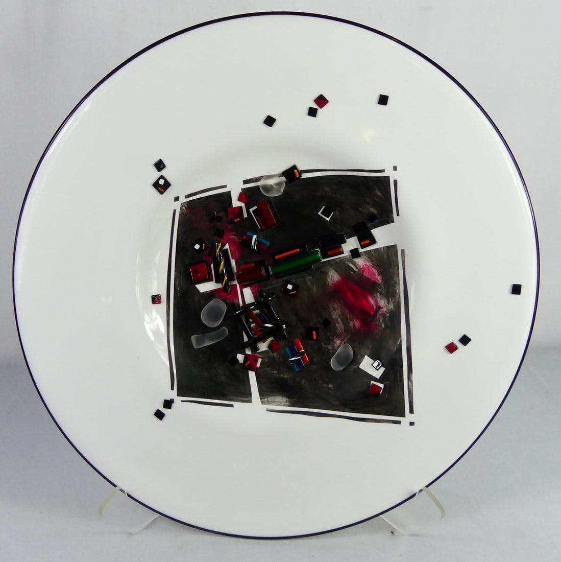 FUSED ART GLASS CHARGER SIGNED: Fused art glass charger, multi-color glass on a white ground. Signed illegibly D. A... and dated 1994 to verso. Measures 21" diameter.