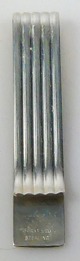 TIFFANY & CO STERLING SILVER FLUTED MONEY CLIP: Tiffany & Co vintage sterling silver fluted money clip. Marked to reverse Tiffany & Co, Sterling. Measures 2 1/16" x 3/8".