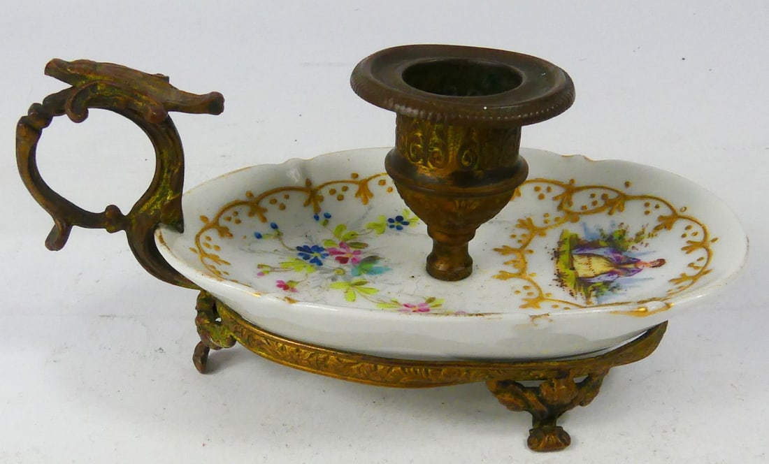 SEVRES STYLE PORCELAIN & GILT METAL CHAMBERSTICK: Sevres style porcelain and gilty metal chamberstick candle holder with hand painted decoration. Marked to underside. Measures 5 3/4" l x 3" w x 2 3/4" h.
