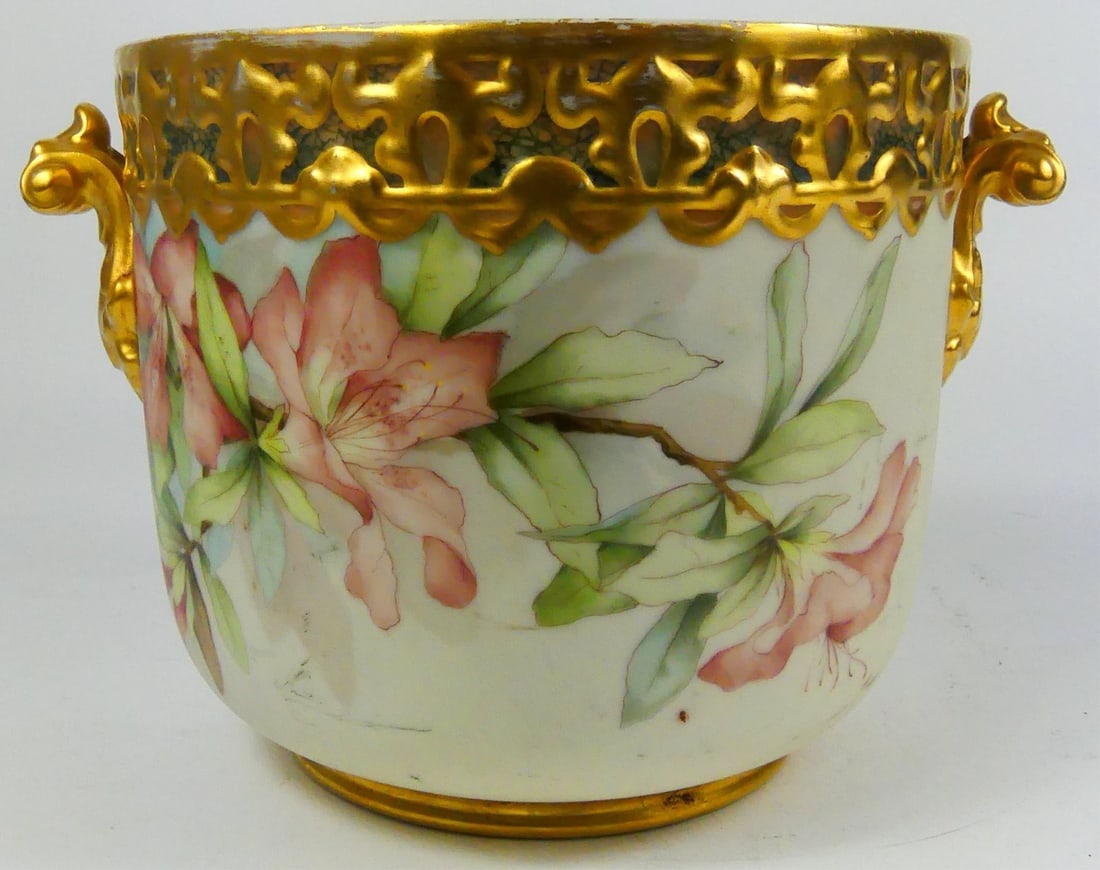 LIMOGES FRENCH GILT & FLORAL PORCELAIN JARDINIERE: Limoges gilt and floral porcelain handled jardiniere. Signed C.E. Ingalls 1893 to underside. Measures 9 3/4" x 6 3/4" h x 8" d.