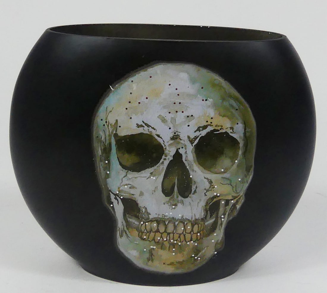 PAINTED GLASS SKULL VASE: Glass vase of rounded form painted black with applied Skull decoration. Signed HIRST in silver paint pen to verso. Measures 7 1/2" w x 6 1/2" h x 3" d.