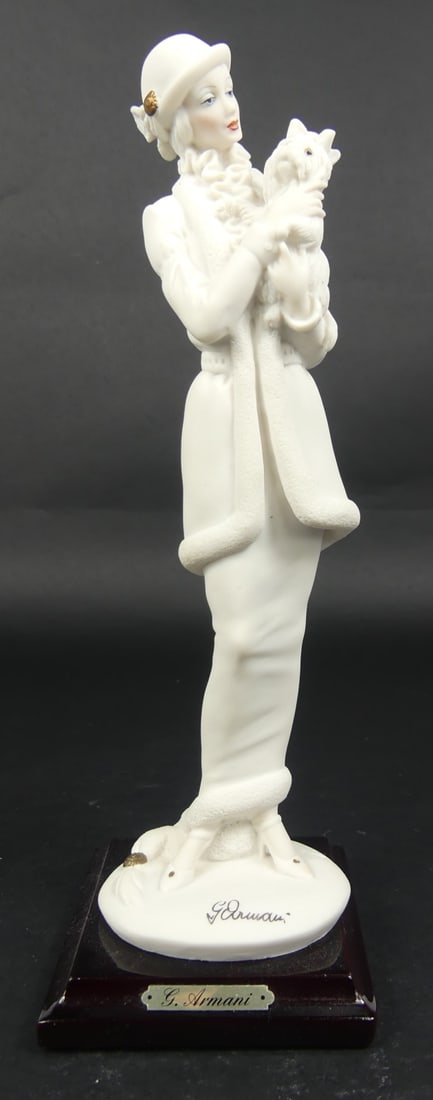 GIUSEPPE ARMANI 'LADY w DOG' FIGURINE: Giuseppe Armani figure depicting a lady holding a dog. Marked to base. Measures 10" height.