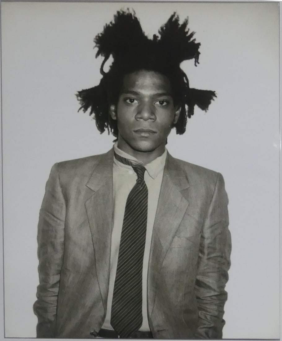 JEAN-MICHEL BASQUIAT PHOTO-LITHO: Jean-Michel Basquiat photo litho. Depicts Basquiat standing. Sheet measures 30" x 23 3/4".