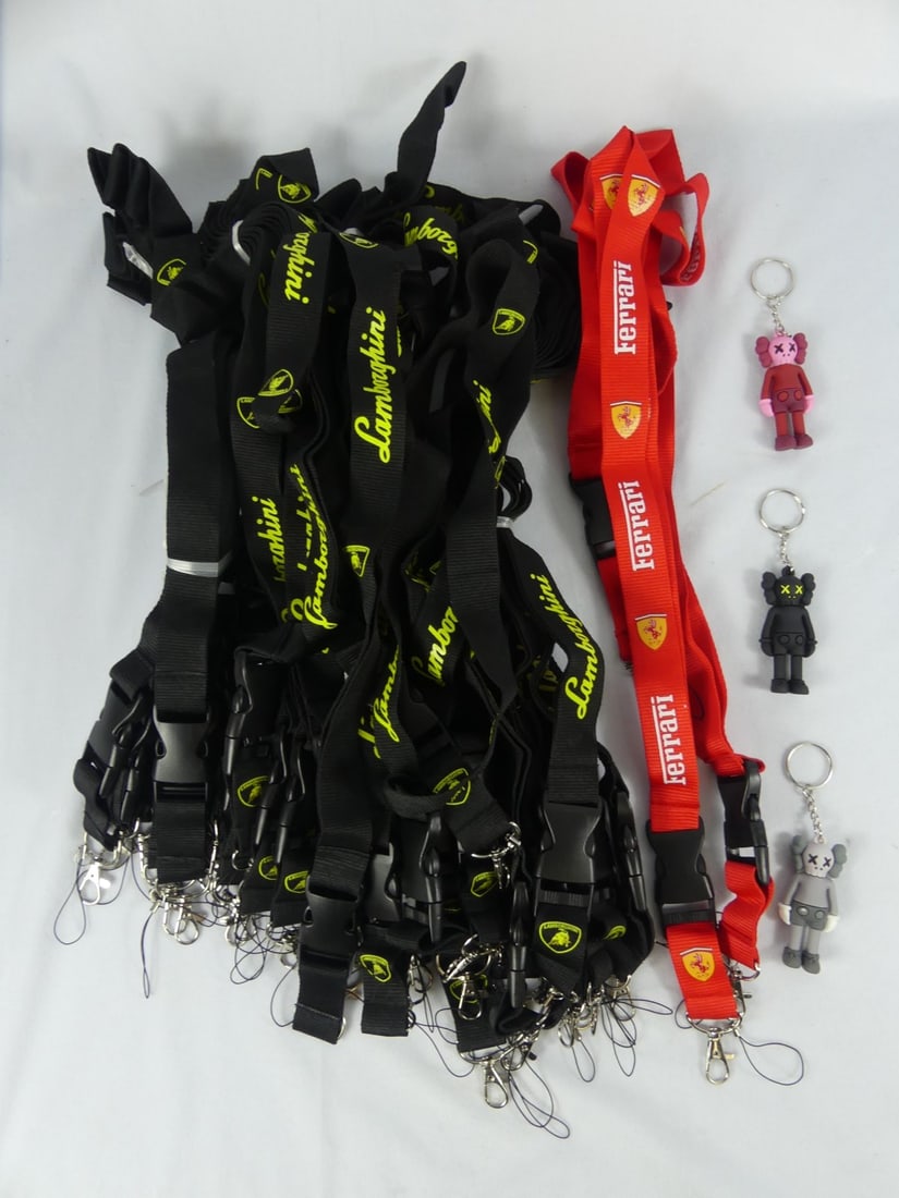 LAMBORGHINI & FERRARI LANYARDS: Collection of black Lamborghini and red Ferrari lanyards with quick detach. Each measures approx 21" length. Also included are three Kaws keychains. Figures measures 2 3/4".