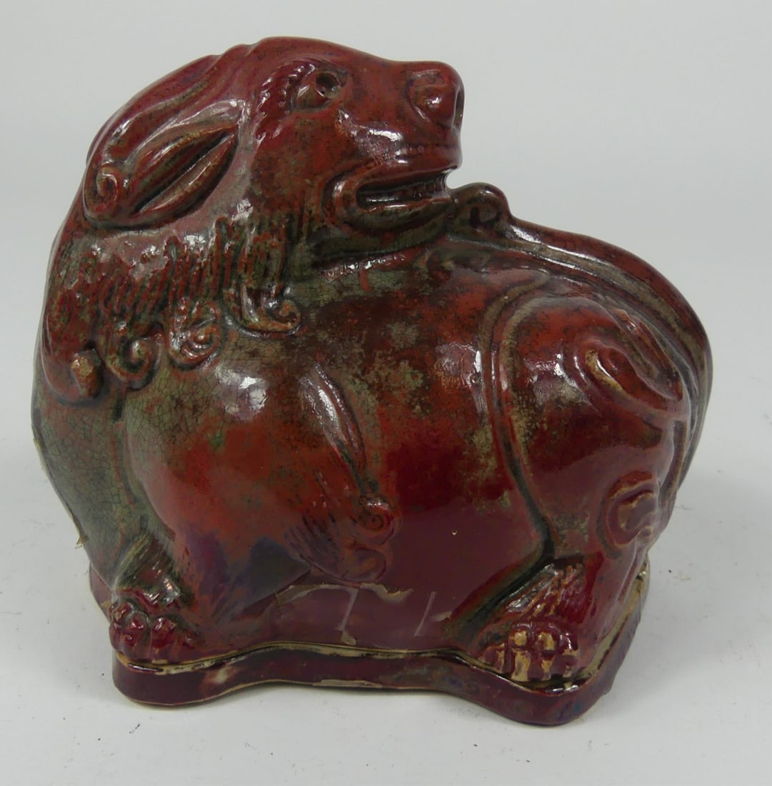 CHINESE RED GLAZED MYTHICAL BEAST INCENSE BURNER: Chinese red glaze incense burner in the form of a mythical beast. Measures 5 3/4" l x 4 5/8" h.