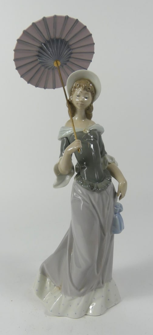 LLADRO 'A SUNNY DAY' PORCELAIN FIGURINE: Lladro 'A Sunny Day' porcelain figure with umbrella. Marked to underside. Measures 13 1/4" height. Note: Appears to be incorrect umbrella.