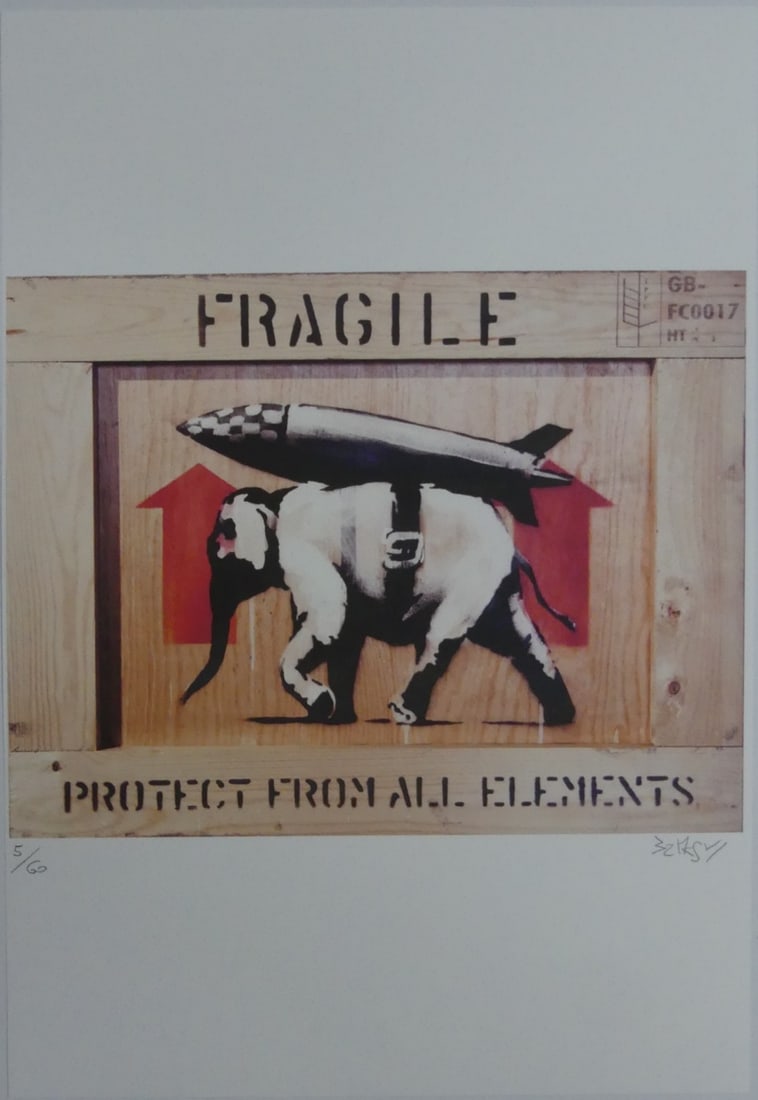 BANKSY 'PROTECT FROM ALL ELEMENTS' LITHOGRAPH: Banksy 'Fragile, Protect From All Elements' elephant with rocket lithograph. Pencil signed lower right. Numbered 5/60 lower left. Sheet measures 19 3/4" x 13 3/4".