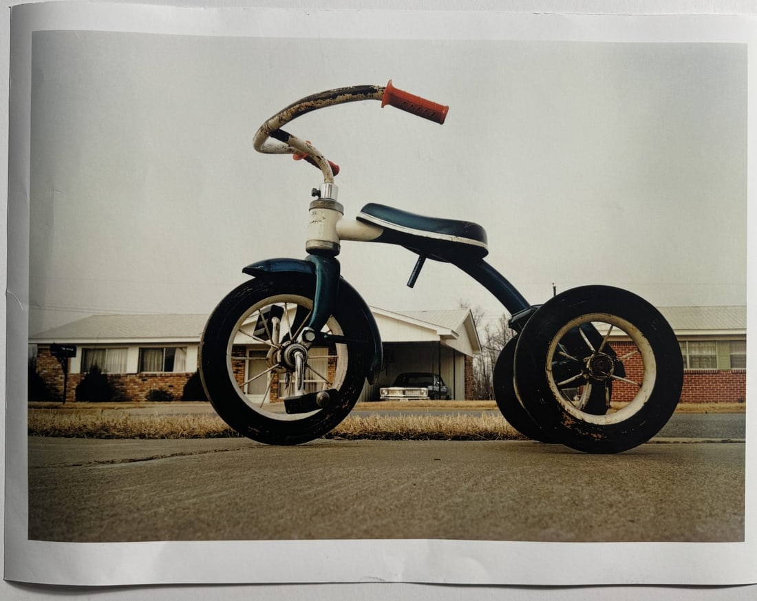 WILLIAM EGGLESTON 'TRICYCLE' PHOTO-LITHO: William Eggleston (American, b. 1939) 'Tricycle' photo-litho. Measures 17 1/2 x 23 1/2 inches.