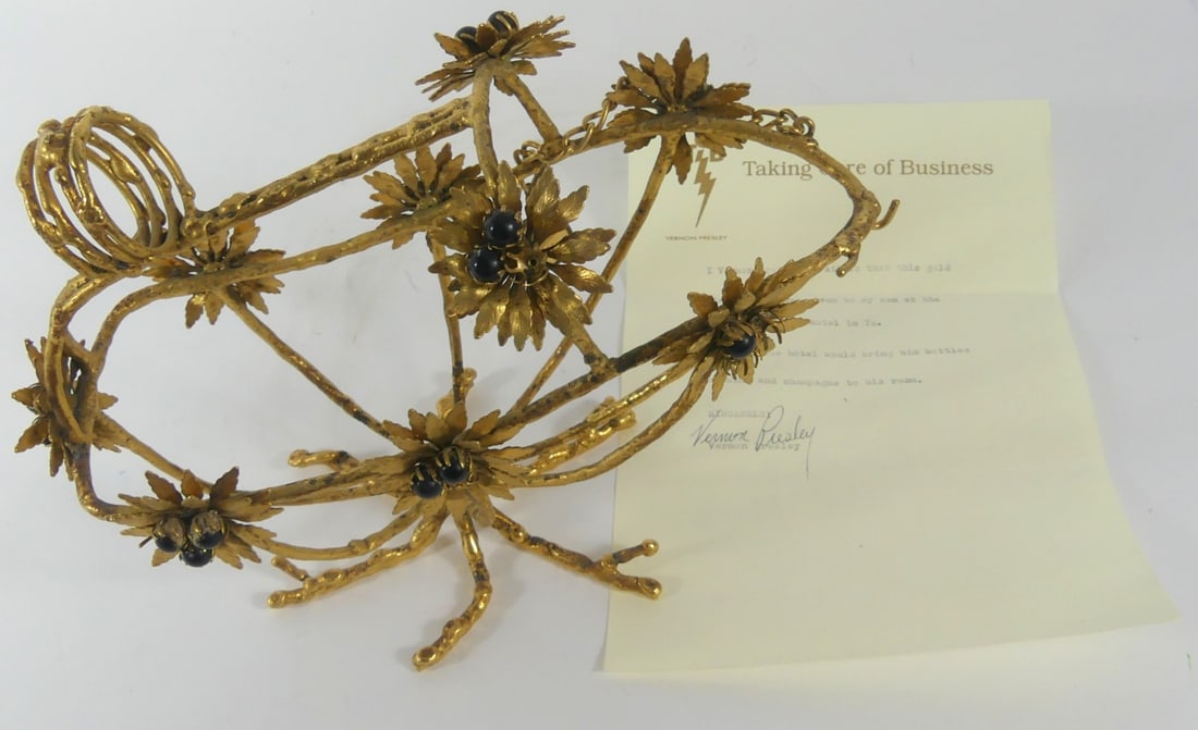 ELVIS PRESLEY 24K GOLD PLATED WINE HOLDER: Elvis Presley owned 24k gold plated floral wine holder from the Las Vegas Hilton Hotel. Includes hand signed letter from Vernon Presley. Wine holder measures 10 1/2" x 5" x 8" height.