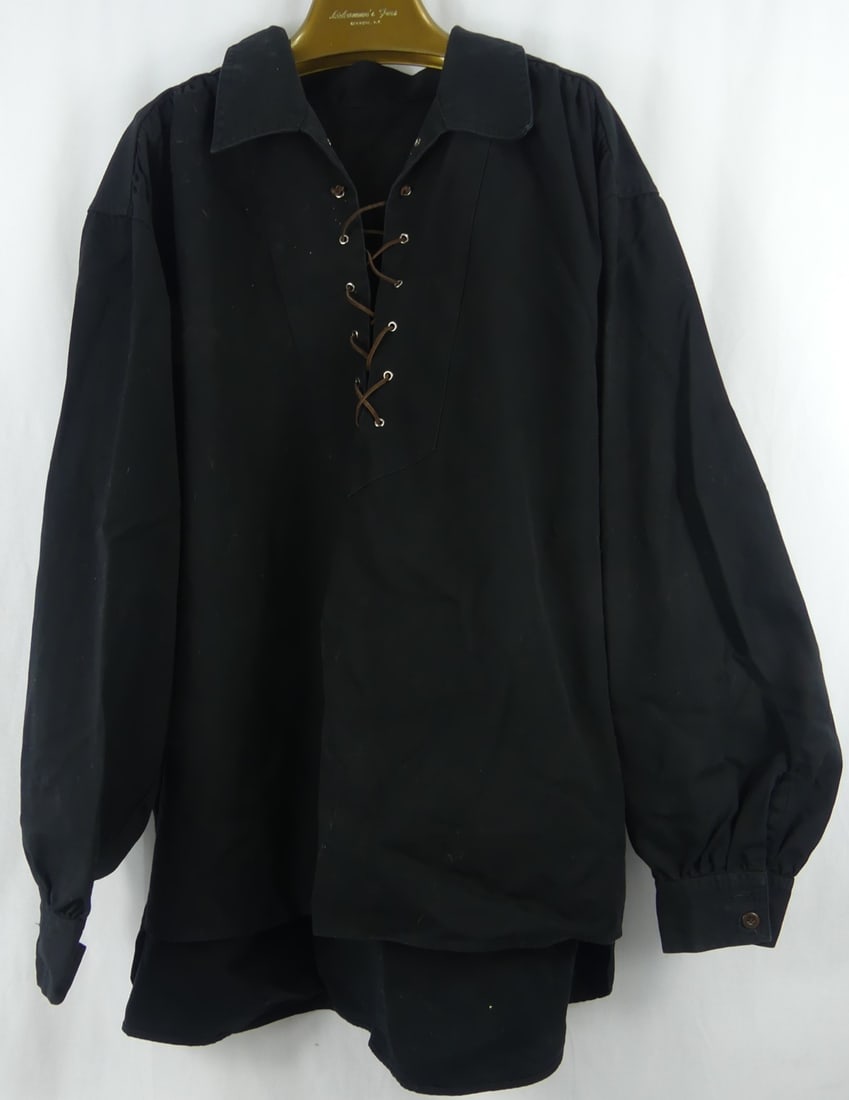ELVIS PRESLEY OWNED BLACK LONG SLEEVE SHIRT: Elvis Presley owned black long sleeve shirt having collar and leather rope closure. Measures approx 34" length x 28" wide. Includes hand signed letter from Vernon Presley dated June 16, 1978.