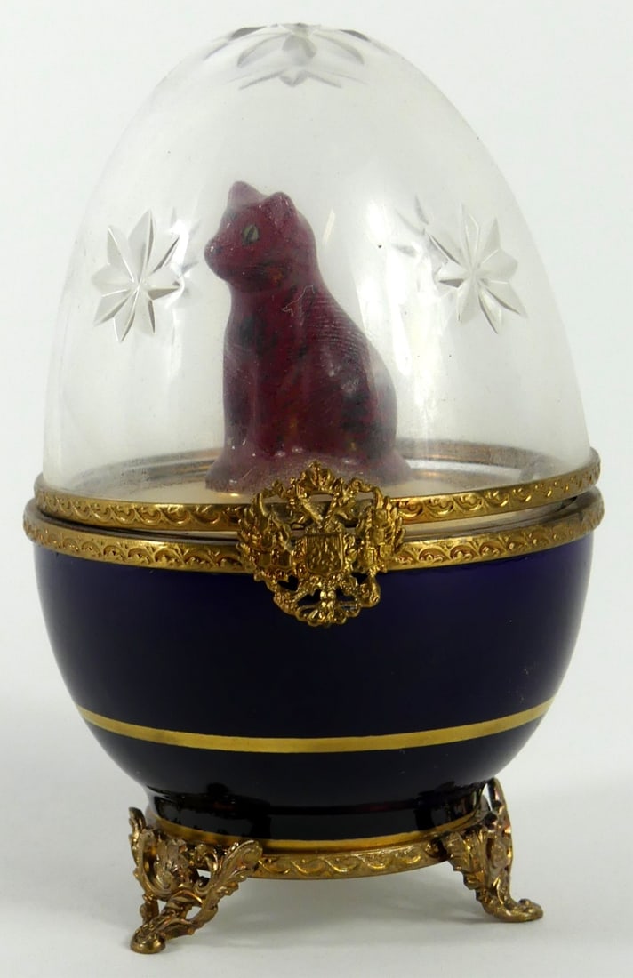 FABERGE LIMOGES EGG w CAT SURPRISE: Faberge Limoges egg. Crystal top and porcelain base. Cat surprise. Marked to underside. Measures 4" x 2 1/2" x 2 1/2".