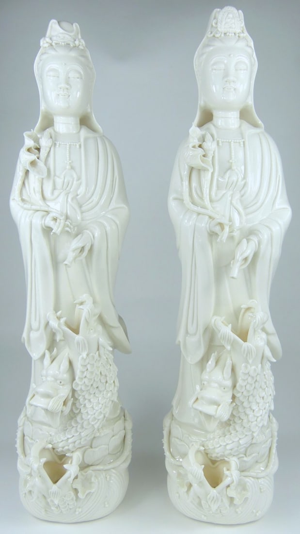 2pc CHINESE BLANC DE CHINE GUAN YIN STATUES: Two Chinese Blanc de Chine porcelain statues depicting Guan Yin with dragon. Each measures 20 1/4" x 5 1/2" x 4 3/4". Each box measures 21 1/4" x 6 1/4" 6".